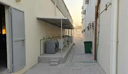 Outdoor communal laundry area with washing machines