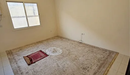 Dedicated prayer room with carpet and prayer mat