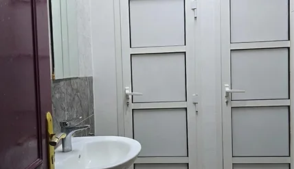 Clean shared washroom facilities with modern fixtures